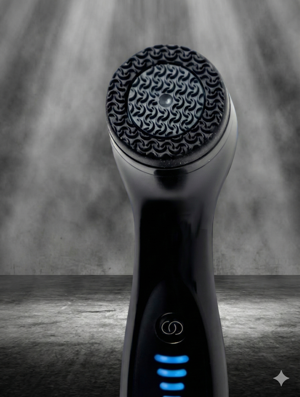 Black LumiSpa device with textured head on a gray background