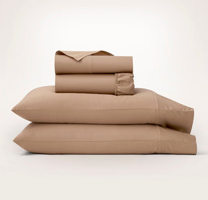 Boll & Branch Signature Hemmed Sheet Set in camel on bed